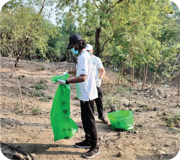 Volunteers organizing and managing collected waste bags after cleanup