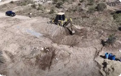 Excavator preparing land for large-scale tree plantation